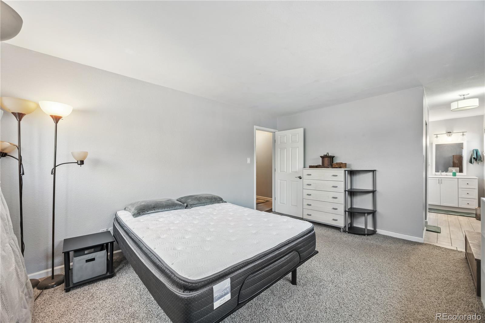 7740 West 35th Avenue, Unit 214 Wheat Ridge, CO 80033 - Photo 12 of 20 a bedroom with a bed and a cabinets