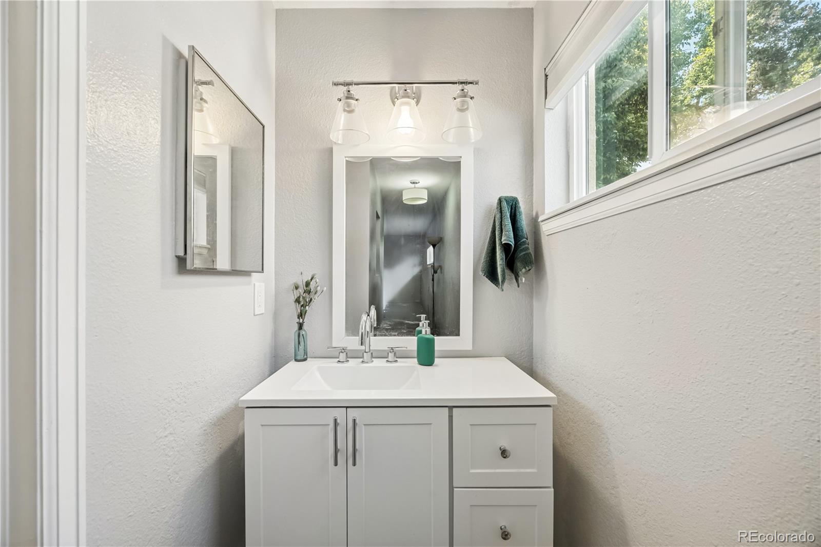 7740 West 35th Avenue, Unit 214 Wheat Ridge, CO 80033 - Photo 14 of 20 a bathroom with a sink and a mirror
