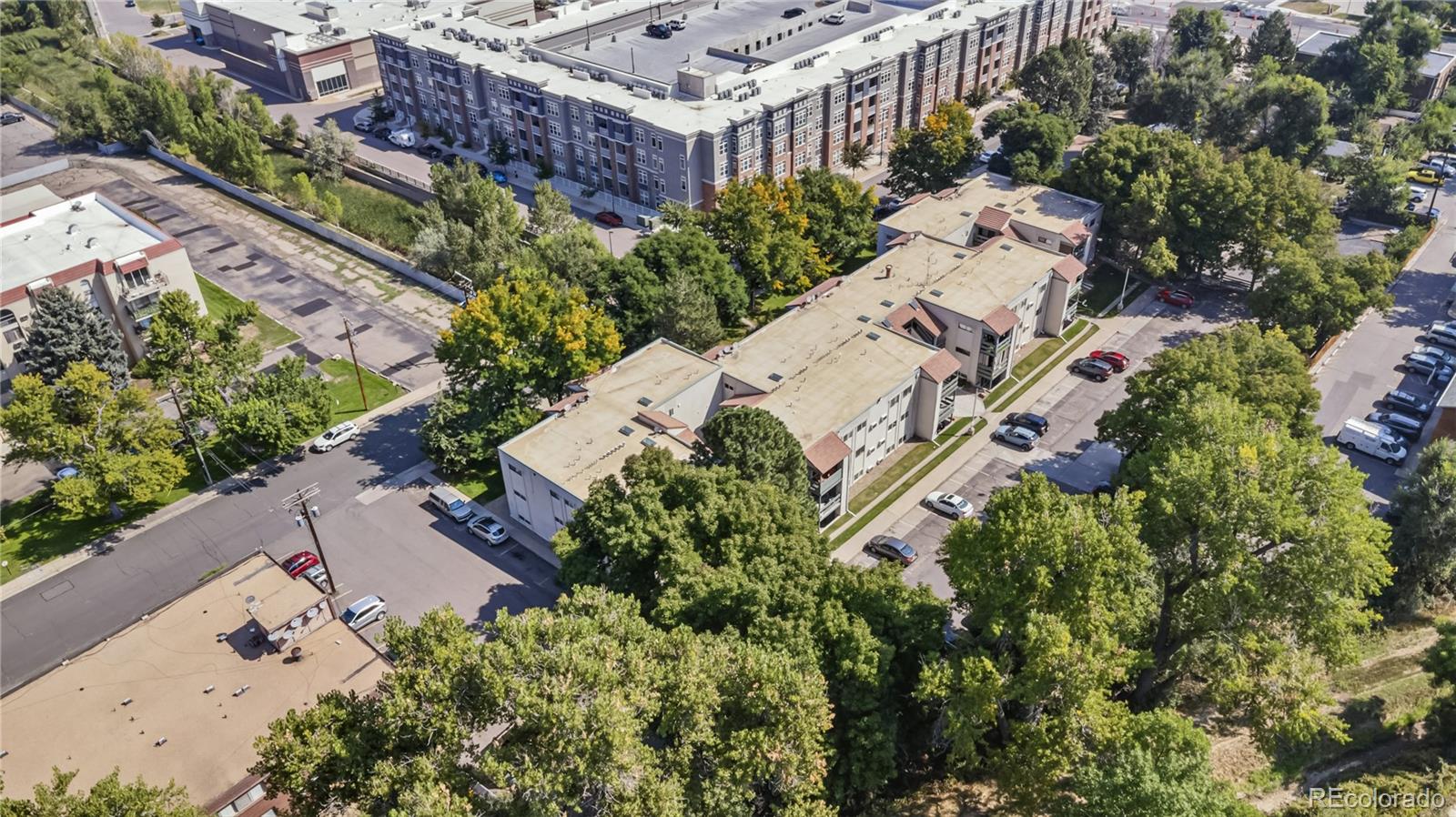 7740 West 35th Avenue, Unit 214 Wheat Ridge, CO 80033 - Photo 18 of 20 an aerial view of a house with a yard and garden