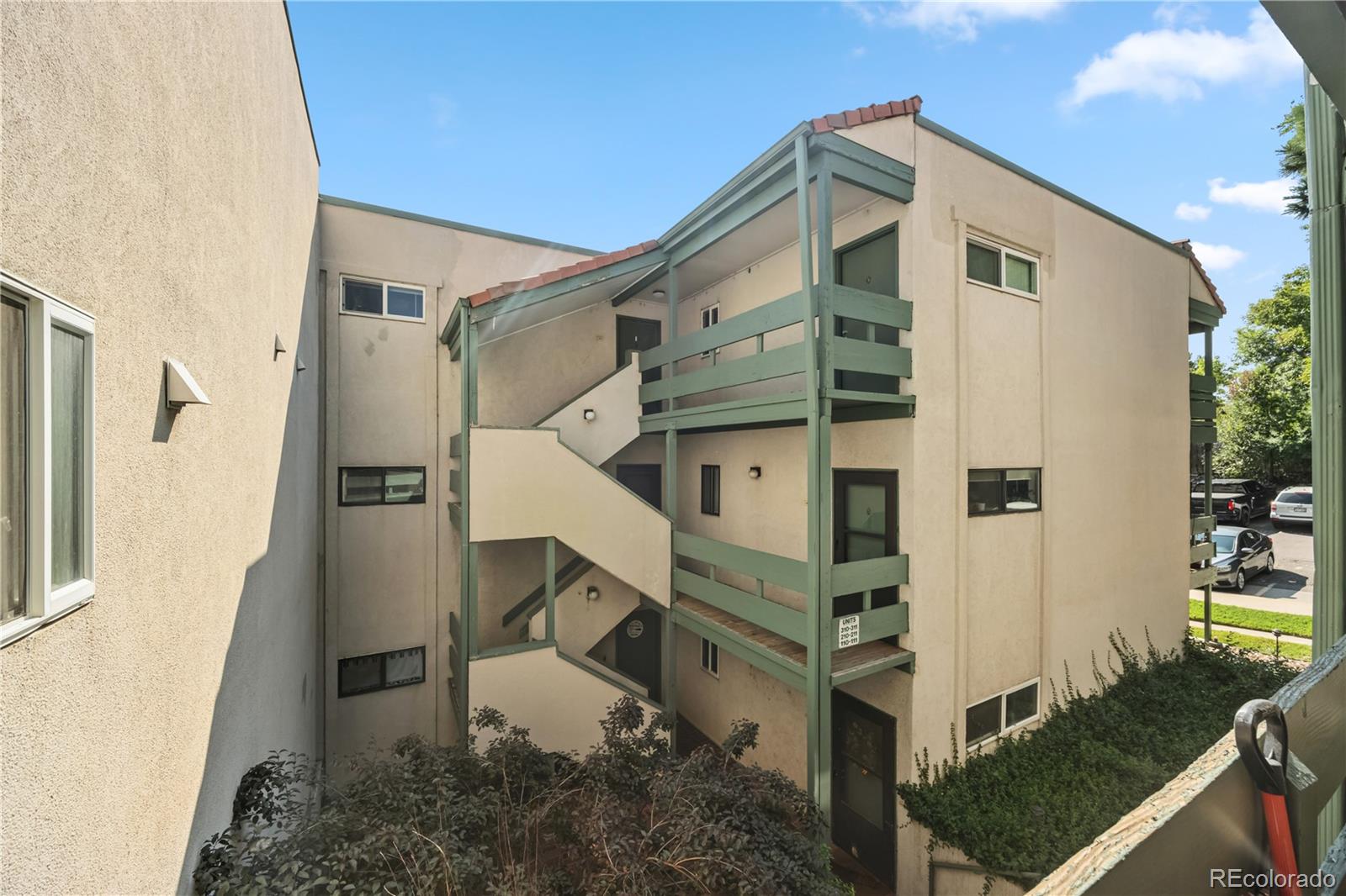 7740 West 35th Avenue, Unit 214 Wheat Ridge, CO 80033 - Photo 2 of 20 a front view of a house with wooden stairs