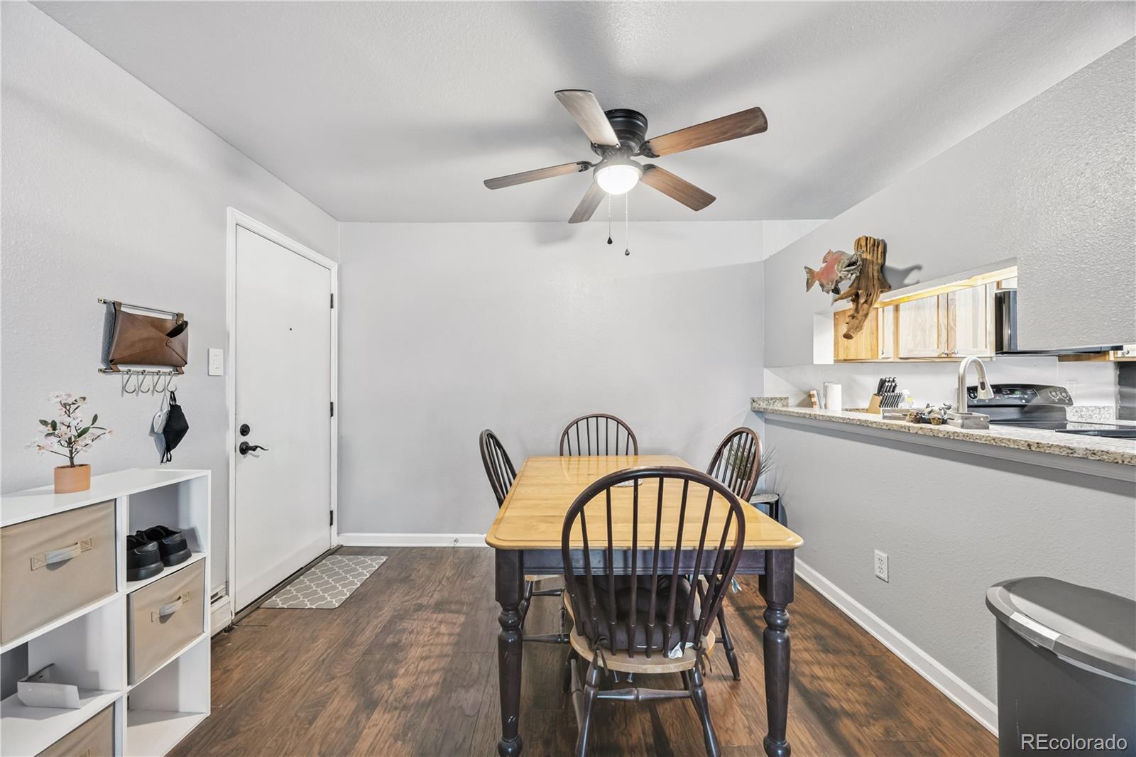 7740 West 35th Avenue, Unit 214 Wheat Ridge, CO 80033 - Photo 3 of 20 a bedroom with a bed and wooden floor