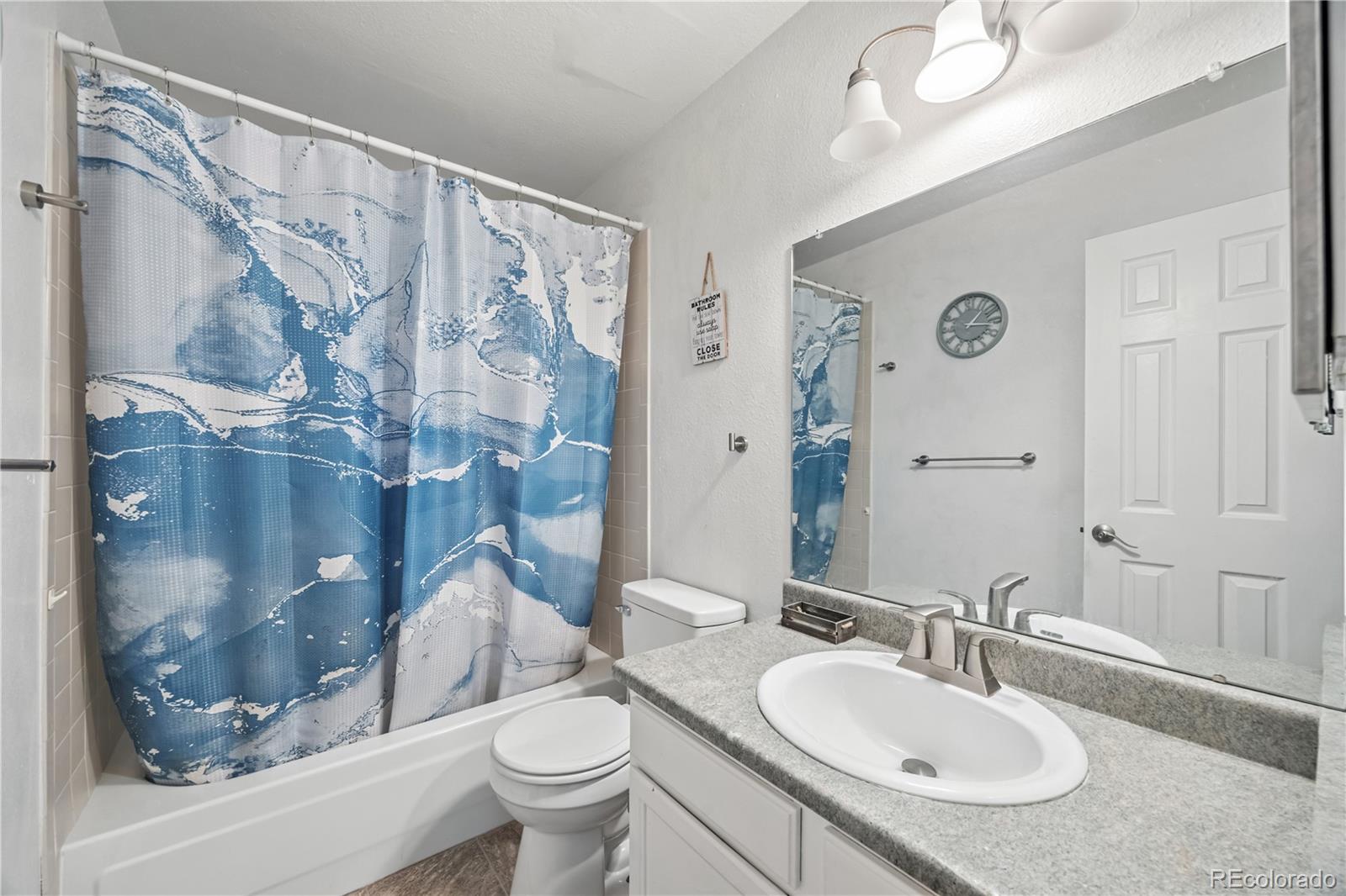 7740 West 35th Avenue, Unit 214 Wheat Ridge, CO 80033 - Photo 8 of 20 a bathroom with a sink toilet and shower