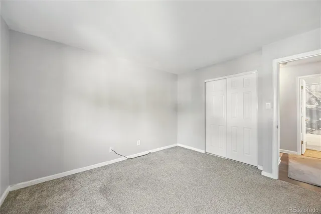 a view of an empty room and a window