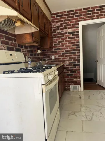 a stove top oven sitting inside of a kitchen