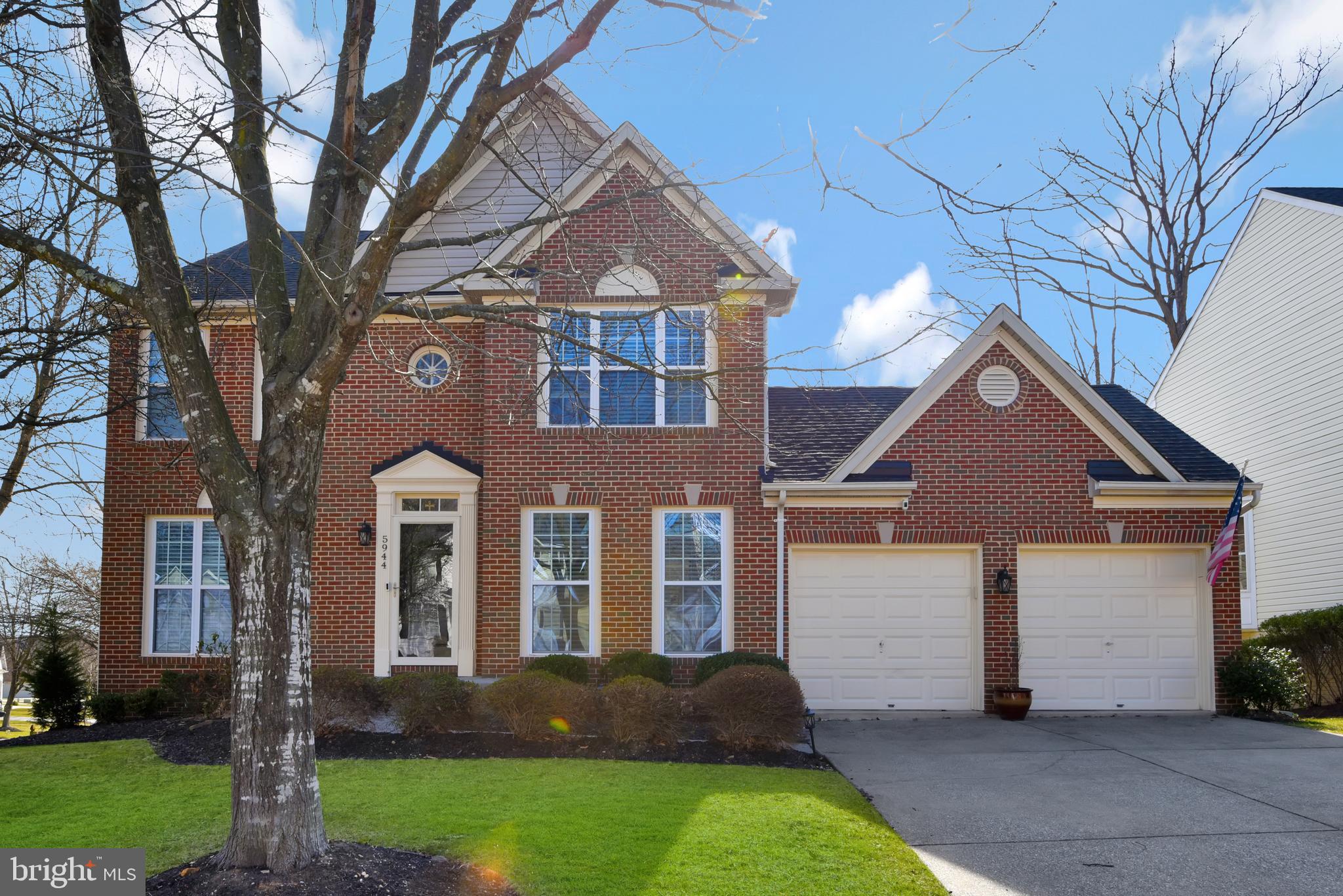 5944 Sandy Ridge Elkridge, MD 21075 - Photo 1 of 42 a front view of a house with a yard and garage