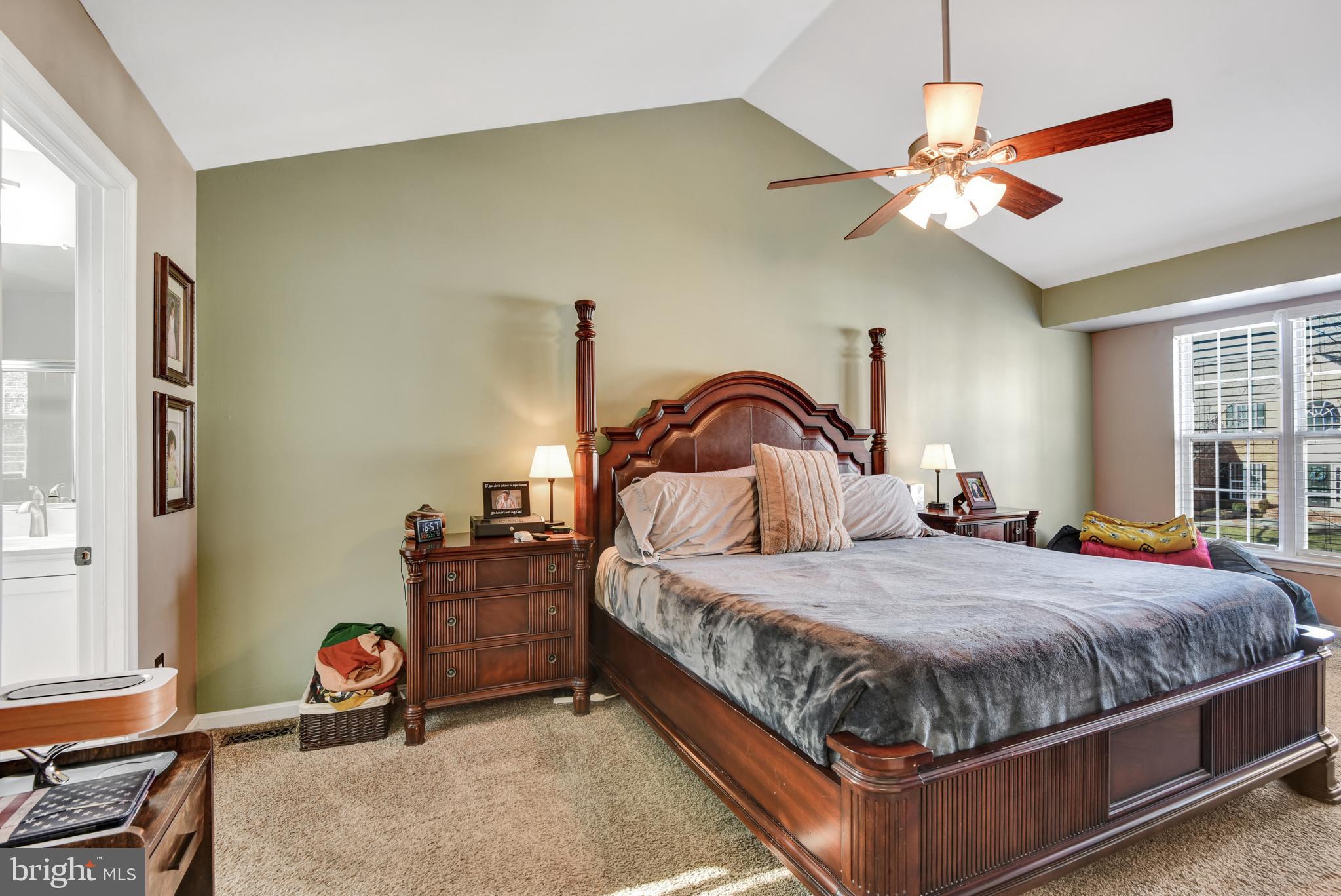 5944 Sandy Ridge Elkridge, MD 21075 - Photo 20 of 42 a bedroom with a bed and ceiling fan