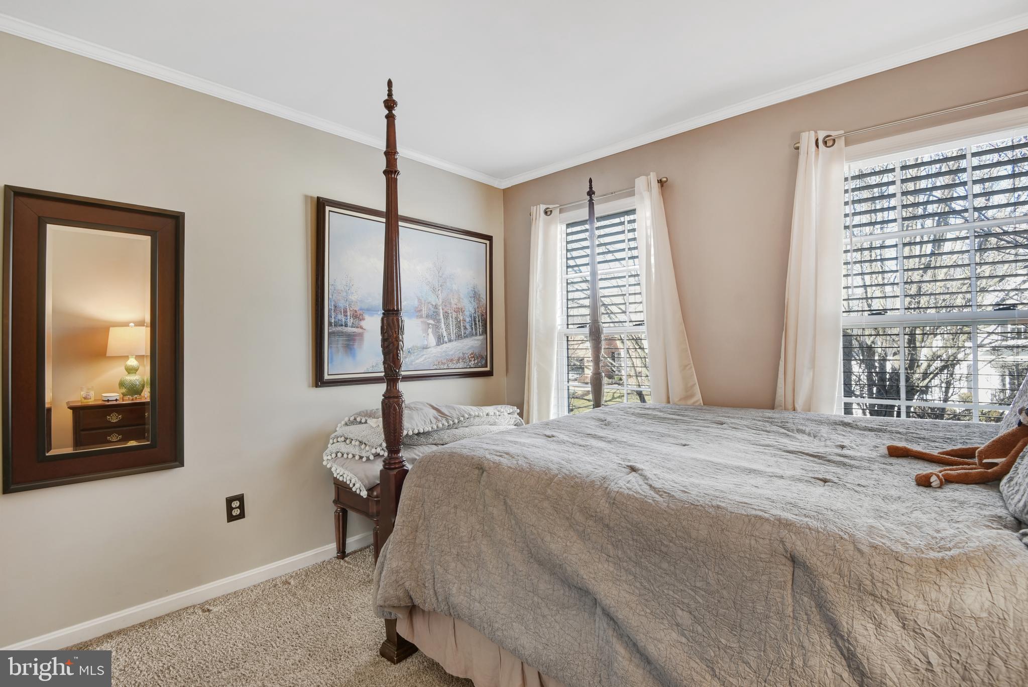 5944 Sandy Ridge Elkridge, MD 21075 - Photo 24 of 42 a bedroom with a bed and large windows