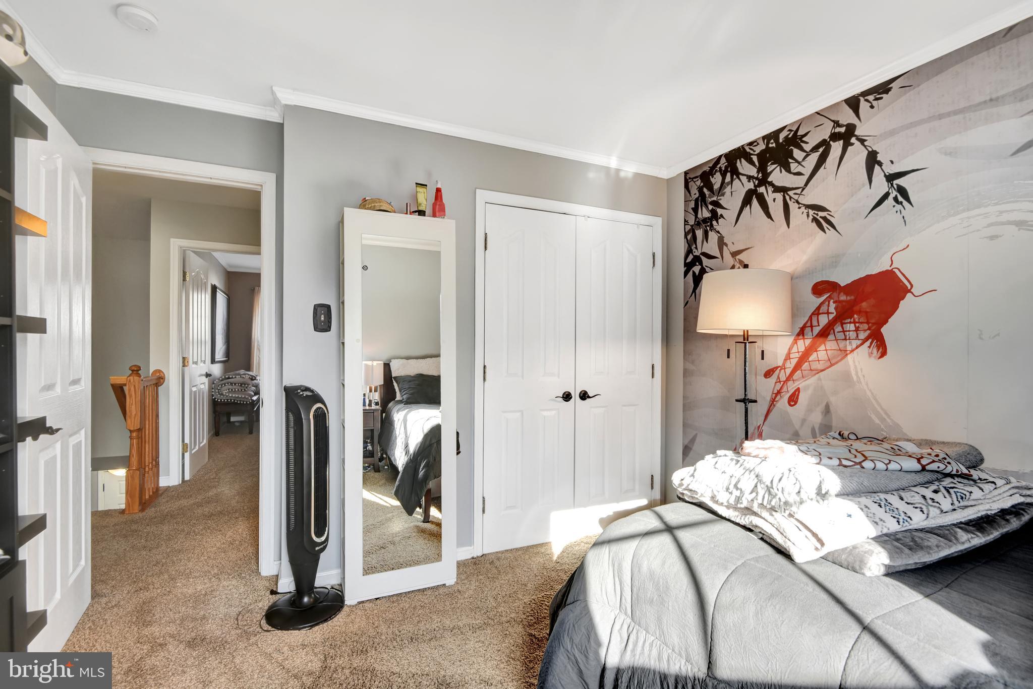 5944 Sandy Ridge Elkridge, MD 21075 - Photo 26 of 42 a bedroom with a bed and a painting on the wall