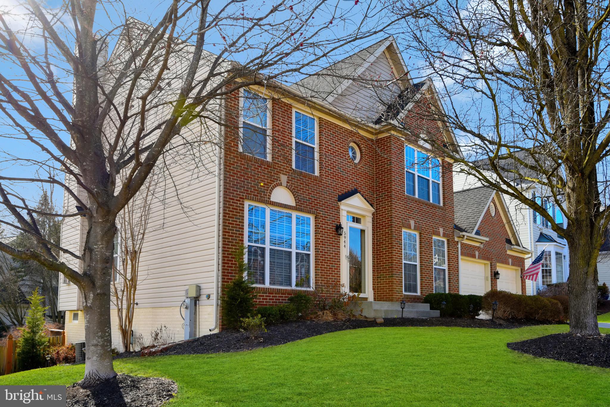 5944 Sandy Ridge Elkridge, MD 21075 - Photo 38 of 42 a front view of a house with garden and trees