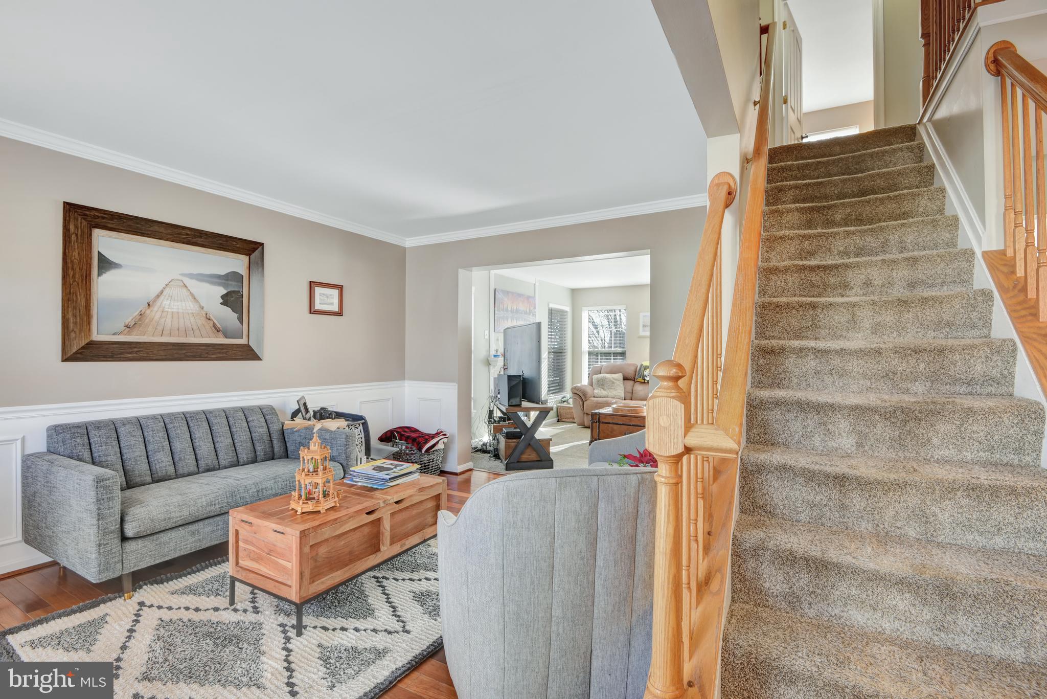 5944 Sandy Ridge Elkridge, MD 21075 - Photo 7 of 42 a living room with furniture and a painting on the wall