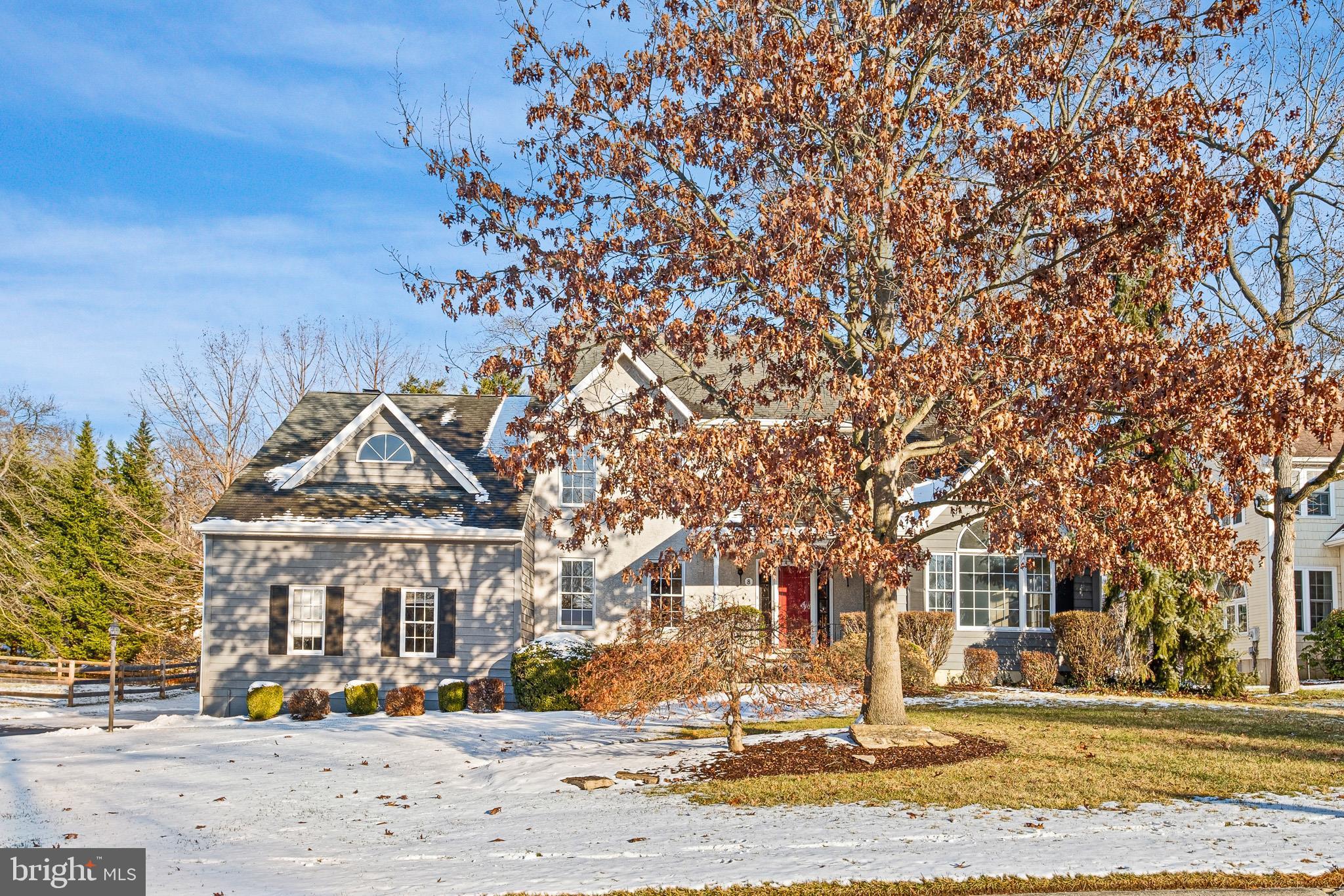 front view of a building with a tree