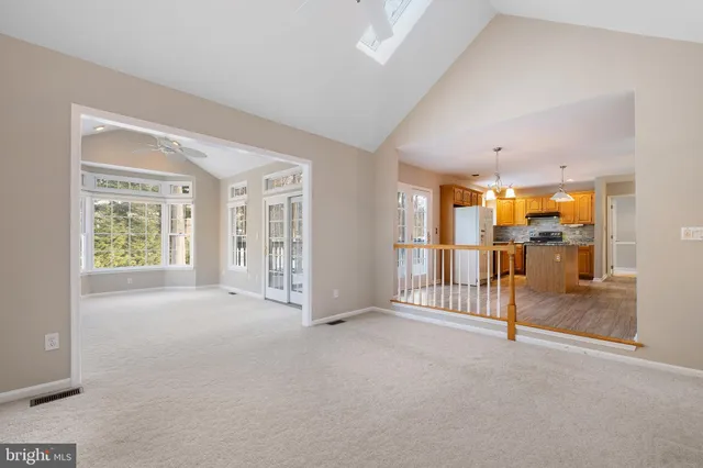 an empty room with fireplace and windows