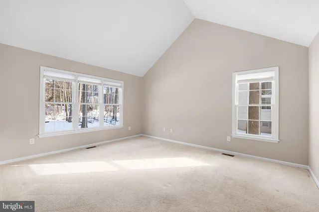 a spacious bathroom with a tub sink and mirror