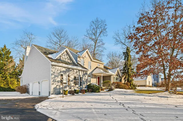 a view of a white house with a road and a yard