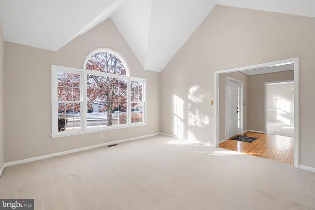 a view of a big room with windows and chandelier