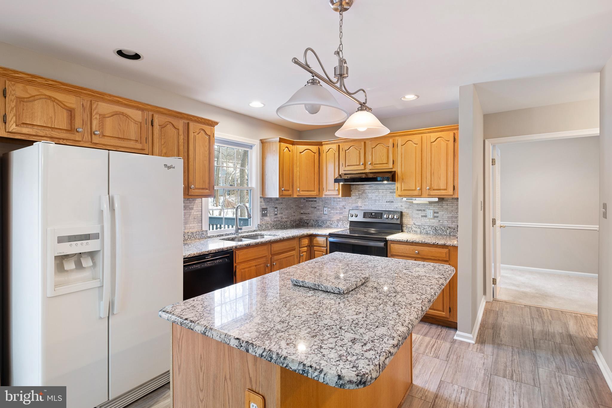 8 Arizona State Drive Newark, DE 19713 - Photo 6 of 32 a kitchen with stainless steel appliances granite countertop a refrigerator a sink dishwasher a stove and white countertops with wooden floor