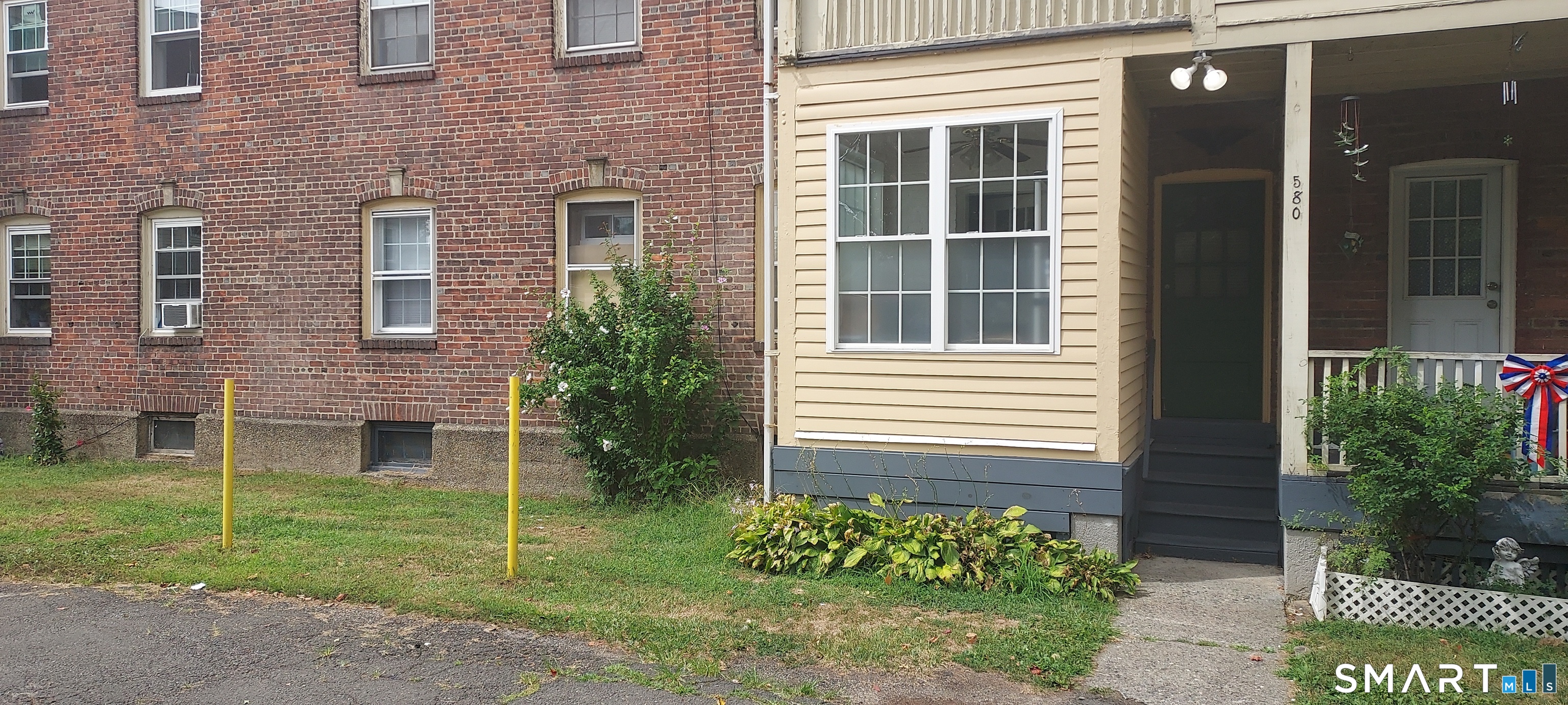580 Wilmot Avenue, Unit 2 Bridgeport, CT 06607 - Photo 2 of 10 a view of a brick house with a yard and a large window
