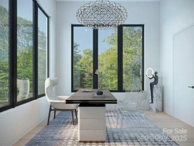 a living room with a furniture and large windows