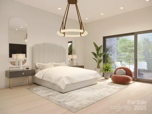 a bedroom with a large bed and a chandelier