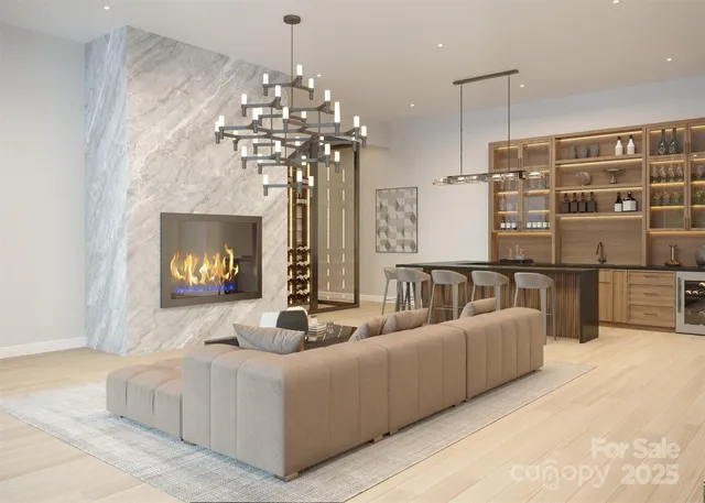 a living room with furniture a chandelier and a fireplace