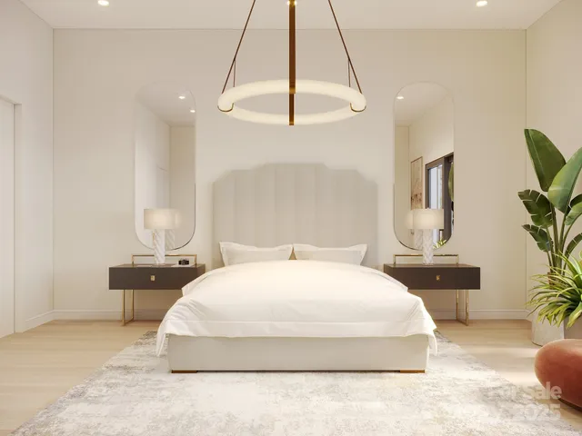 a bedroom with a large bed and a chandelier