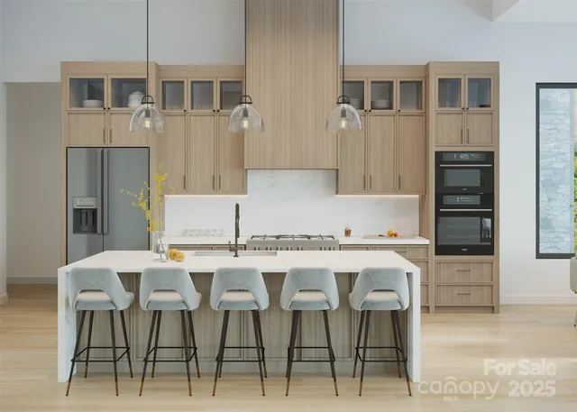a kitchen with stainless steel appliances kitchen island granite countertop a table and chairs