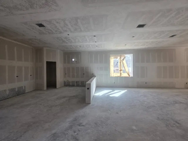 an empty room with a window and a fireplace