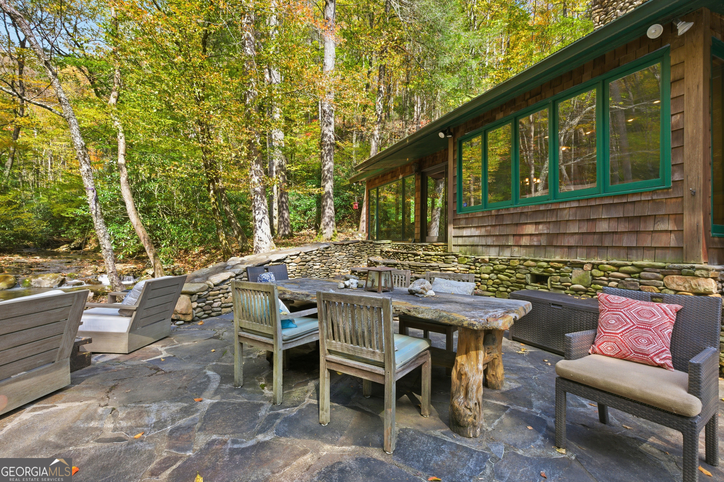 2965 Tate City Road Hayesville, NC 28904 - Photo 12 of 49 a view of a patio with table and chairs and couches with wooden fence and plants