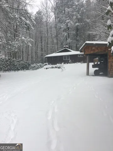 a view of a house with a snow in the yard