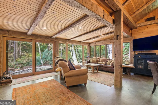 a living room with furniture tv and a large window