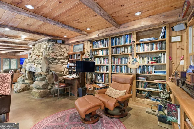 a living room with furniture and a book shelf