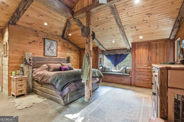 a spacious bedroom with a bed and a dresser