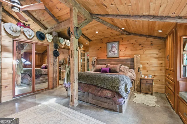 a bedroom with a bed and a mirror