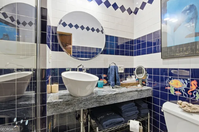 a bathroom with a granite countertop double vanity sink and a mirror