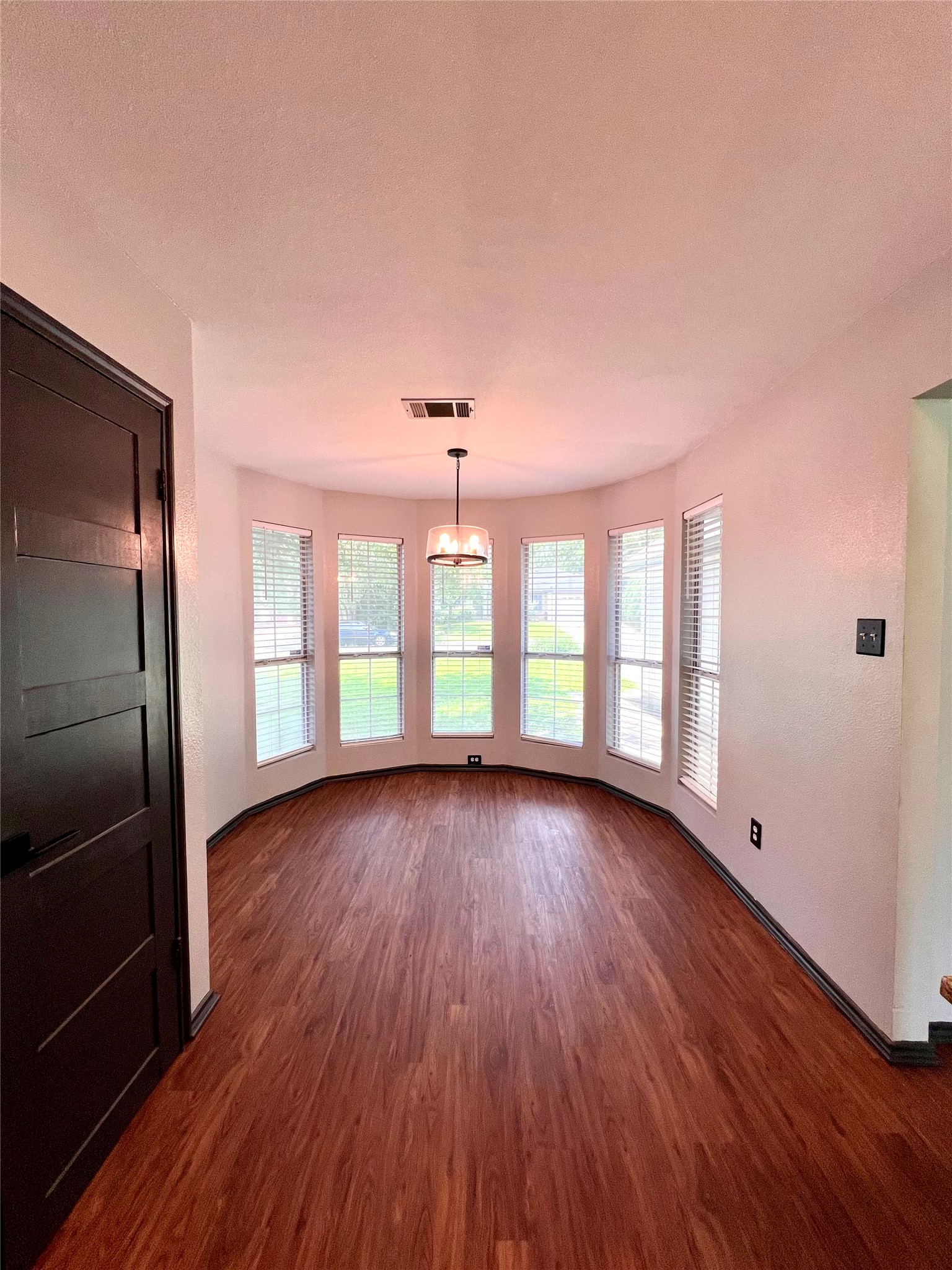 5404 China Berry Road Austin, TX 78744 - Photo 7 of 20 Luminous dining area showcasing beautiful wood flooring and abundant natural light.