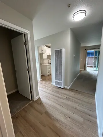 an empty room with wooden floor and a window