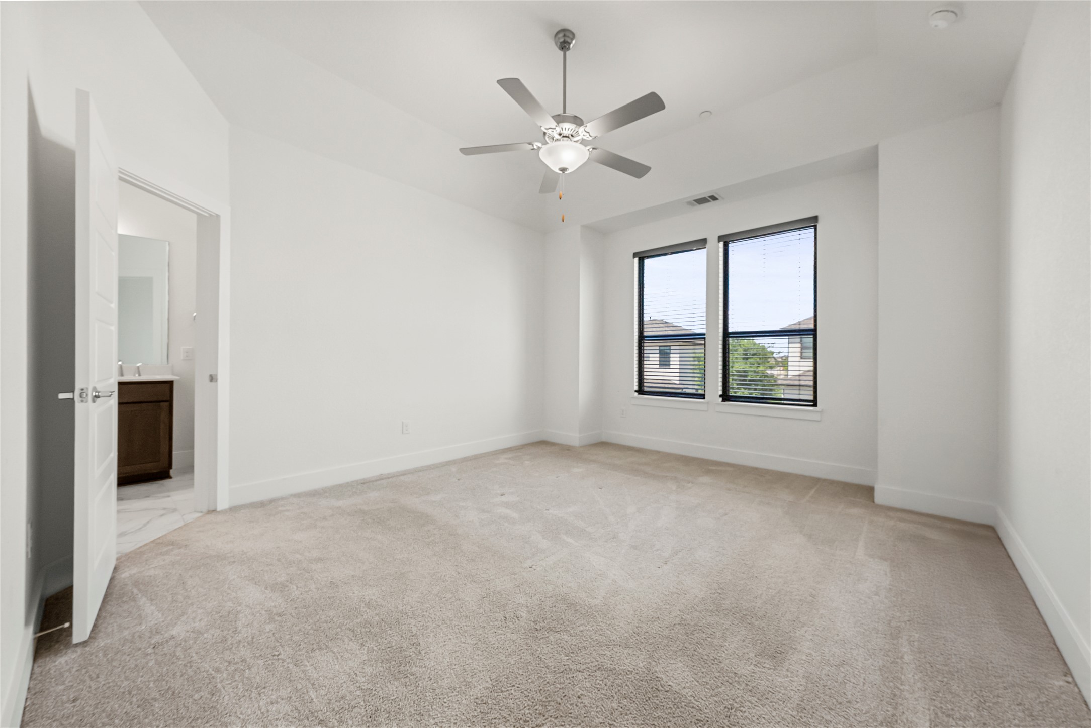 12315 Maypole Bend, Unit 1002 Austin, TX 78717 - Photo 8 of 29 Empty room featuring light colored carpet and ceiling fan