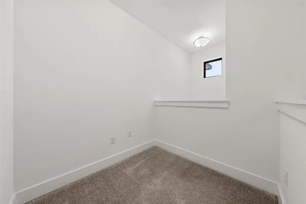 a view of an empty room with a fan