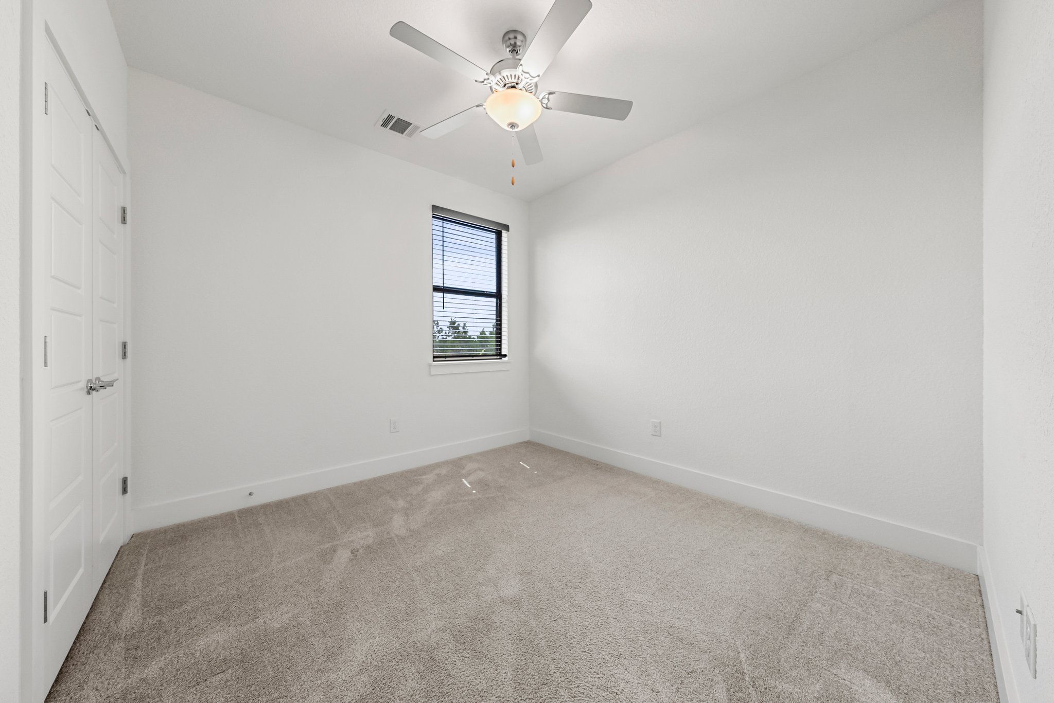 12315 Maypole Bend, Unit 1002 Austin, TX 78717 - Photo 17 of 29 Unfurnished bedroom featuring carpet flooring, a closet, and a ceiling fan