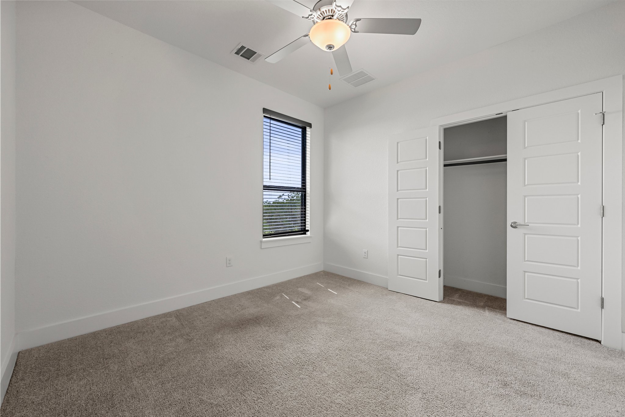 12315 Maypole Bend, Unit 1002 Austin, TX 78717 - Photo 21 of 29 Unfurnished bedroom with carpet flooring, a ceiling fan, and a closet