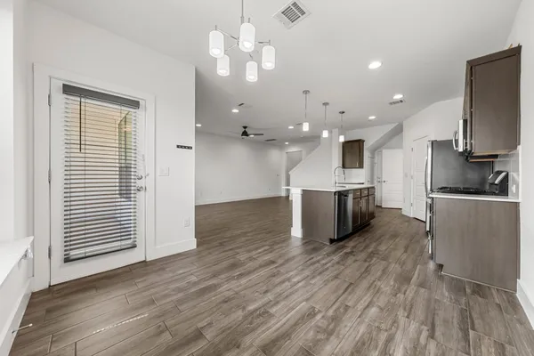 a view of a house with a small yard and deck