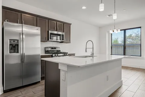 a view of kitchen with cabinets and wooden floor