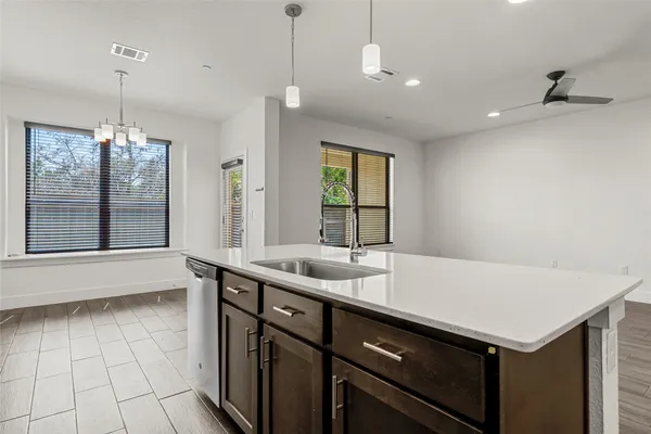 an open kitchen with a refrigerator and a stove top oven