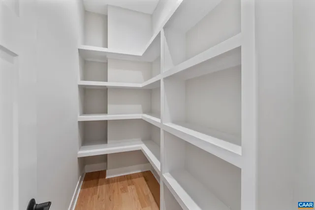 a view of a dining room with furniture a chandelier and wooden floor