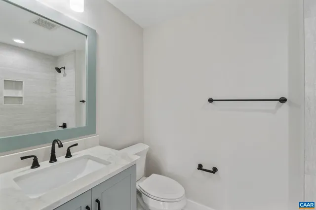 a kitchen with granite countertop white cabinets and white stainless steel appliances