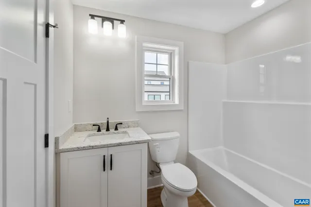 a front view of a house with a garden and yard