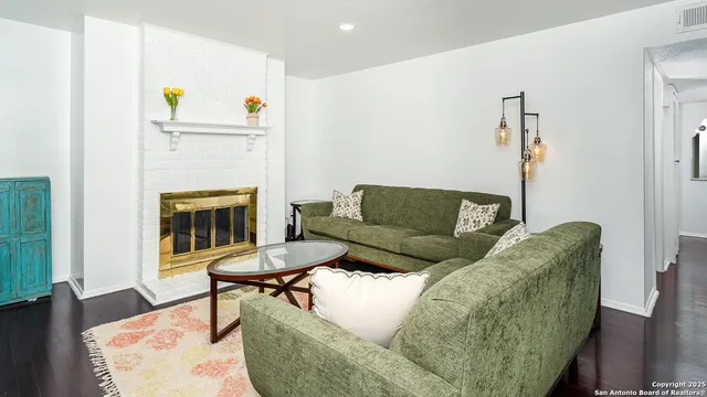 a living room with furniture and a fireplace