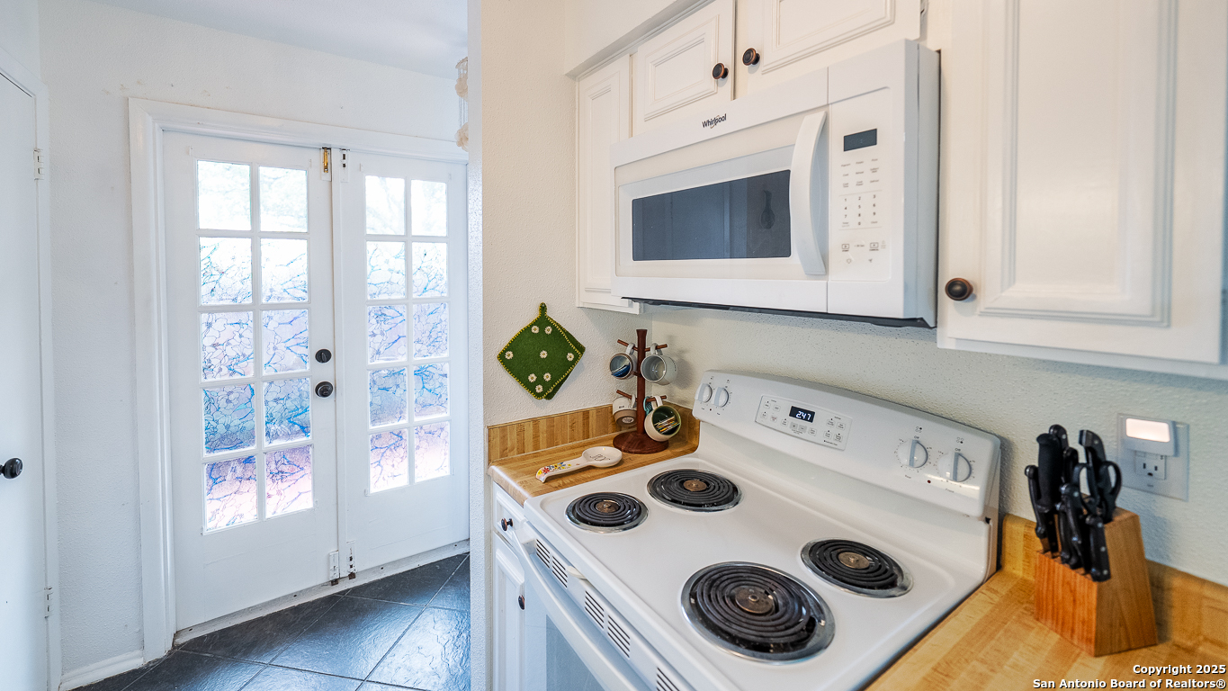 7711 Callaghan Road, Unit 714 San Antonio, TX 78229 - Photo 19 of 22 a kitchen with a stove and a microwave