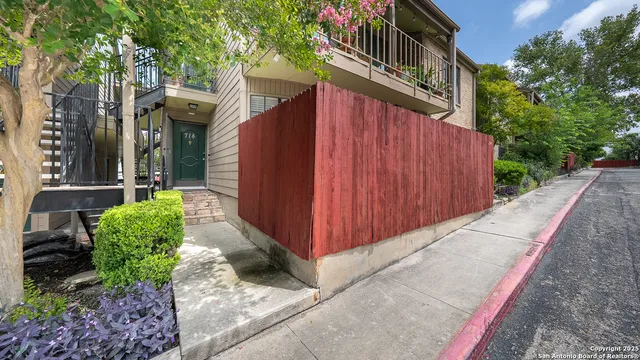 a view of a house with brick walls