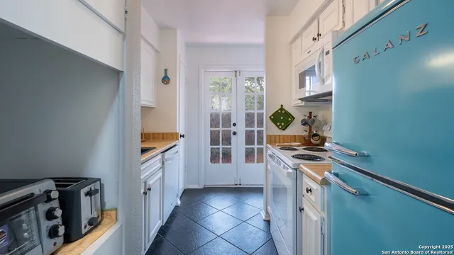 a kitchen with stainless steel appliances a stove a sink and a refrigerator